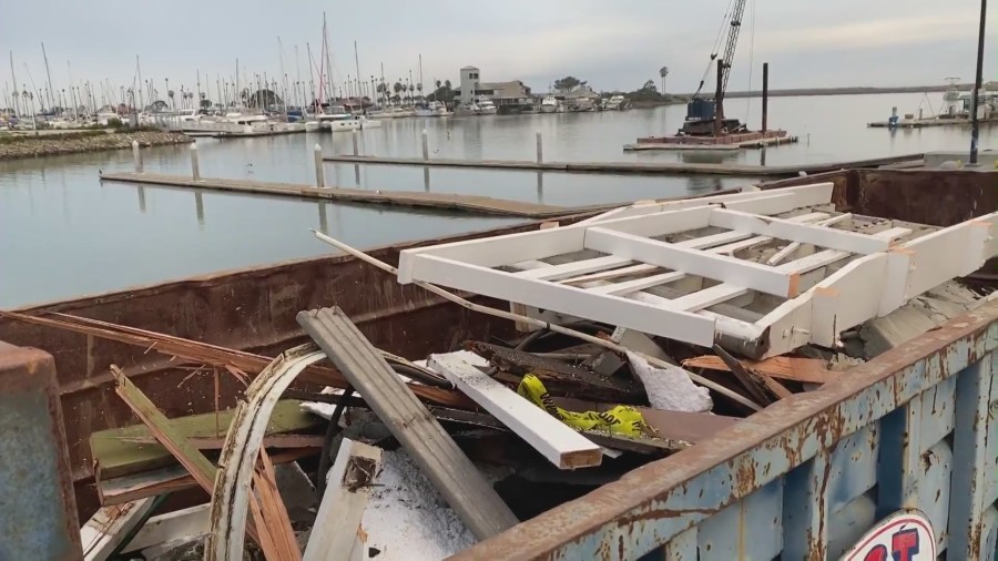 Broken docks pile up in a dumpster at the Ventura Harbor on Jan. 8, 2022.