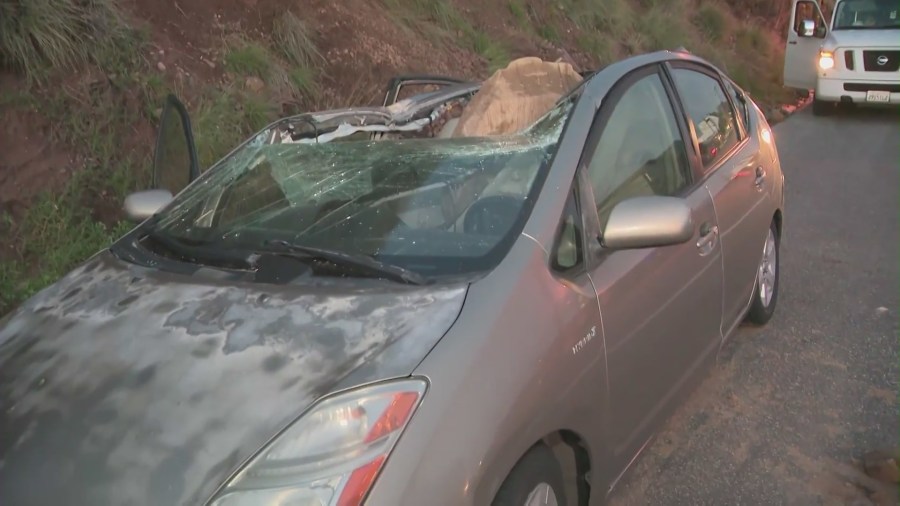 The aftermath of a giant boulder crushing a car as it tumbled off a Malibu hillside on Jan. 10, 2023. (KTLA)