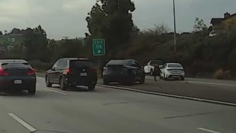 Tesla driver confronting a white sedan on an exit shoulder in Glendale. (DroneZone_LA)