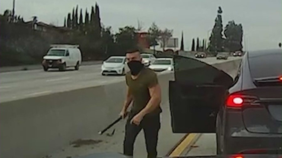 A man is seen getting out of a Tesla SUV and attacking a victim with a large pipe along the 2 Freeway on Jan. 11, 2023. (DroneZone_LA)