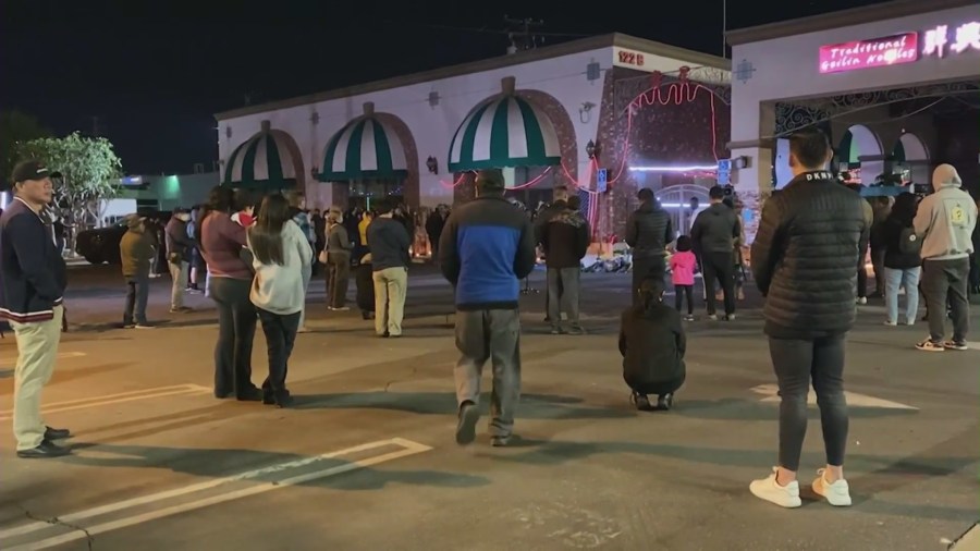 A community held a candlelight vigil outside the Star Ballroom Dance Studio in Monterey Park to remember loved ones lost during a mass shooting. (KTLA)