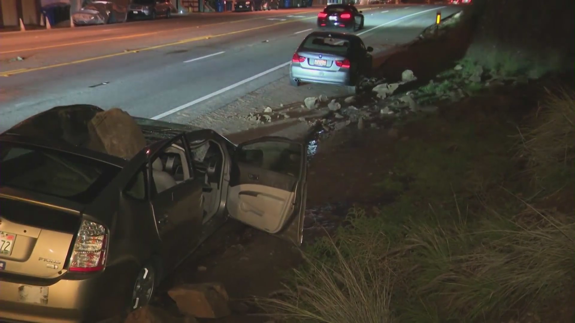 The aftermath of a giant boulder crushing a car as it tumbled off a Malibu hillside on Jan. 10, 2023. (KTLA)