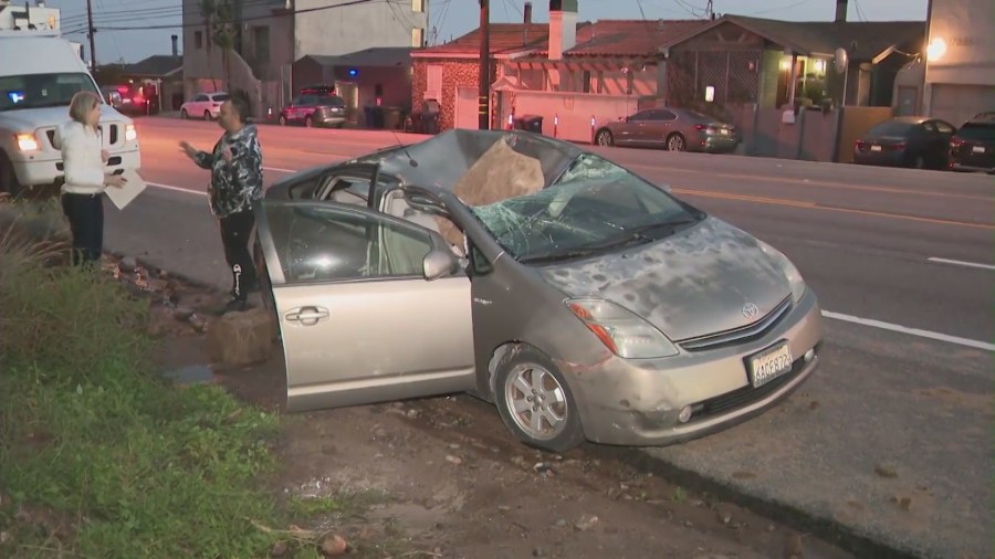 The aftermath of a giant boulder crushing a car as it tumbled off a Malibu hillside on Jan. 10, 2023. (KTLA)