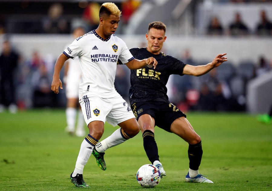 Efrain Alvarez #26 of Los Angeles Galaxy controls the ball against Danny Musovski #29 of Los Angeles FC in the first half at Banc of California Stadium on July 8, 2022 in Los Angeles. (Ronald Martinez/Getty Images)