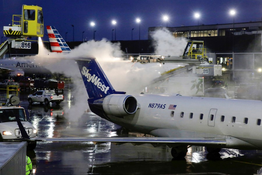 A deicing agent is applied to a SkyWest airplane before its takeoff from O'Hare International Airport on Jan. 18, 2019, in this file photo. (AP Photo/Kiichiro Sato, File)