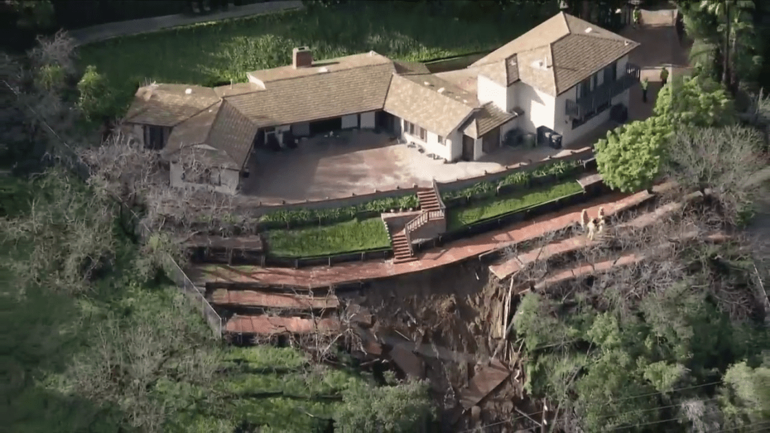 A home in the Beverly Crest neighborhood of Los Angeles is threatened by a mud and debris flow on Feb. 28,