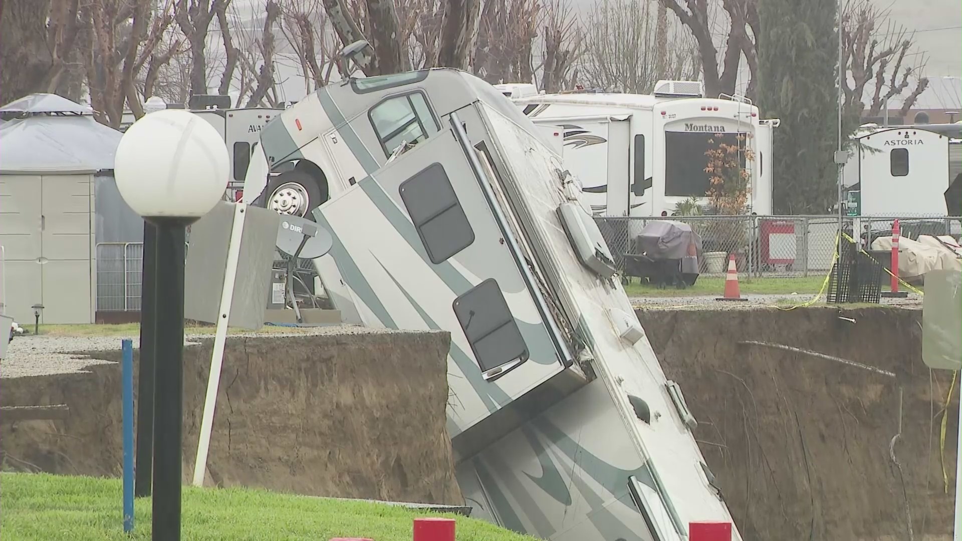 An RV tumbling off an embankment and into a river in Castaic on Feb. 25, 2023. (KTLA)