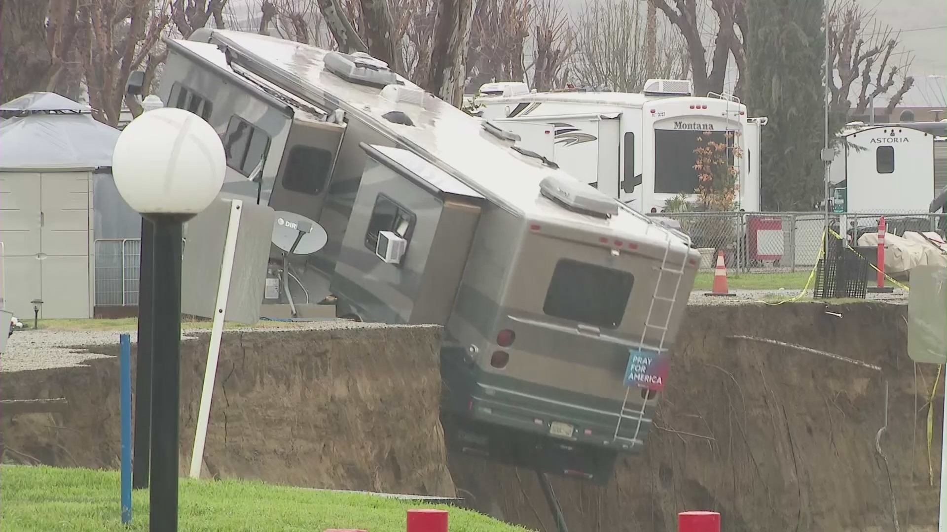 An RV tumbling off an embankment and into a river in Castaic on Feb. 25, 2023. (KTLA)