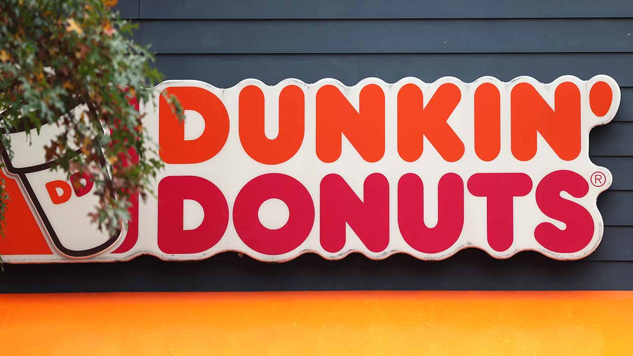 A Dunkin' storefront sign is seen in New York City. (Michael M. Santiago/Getty Images)