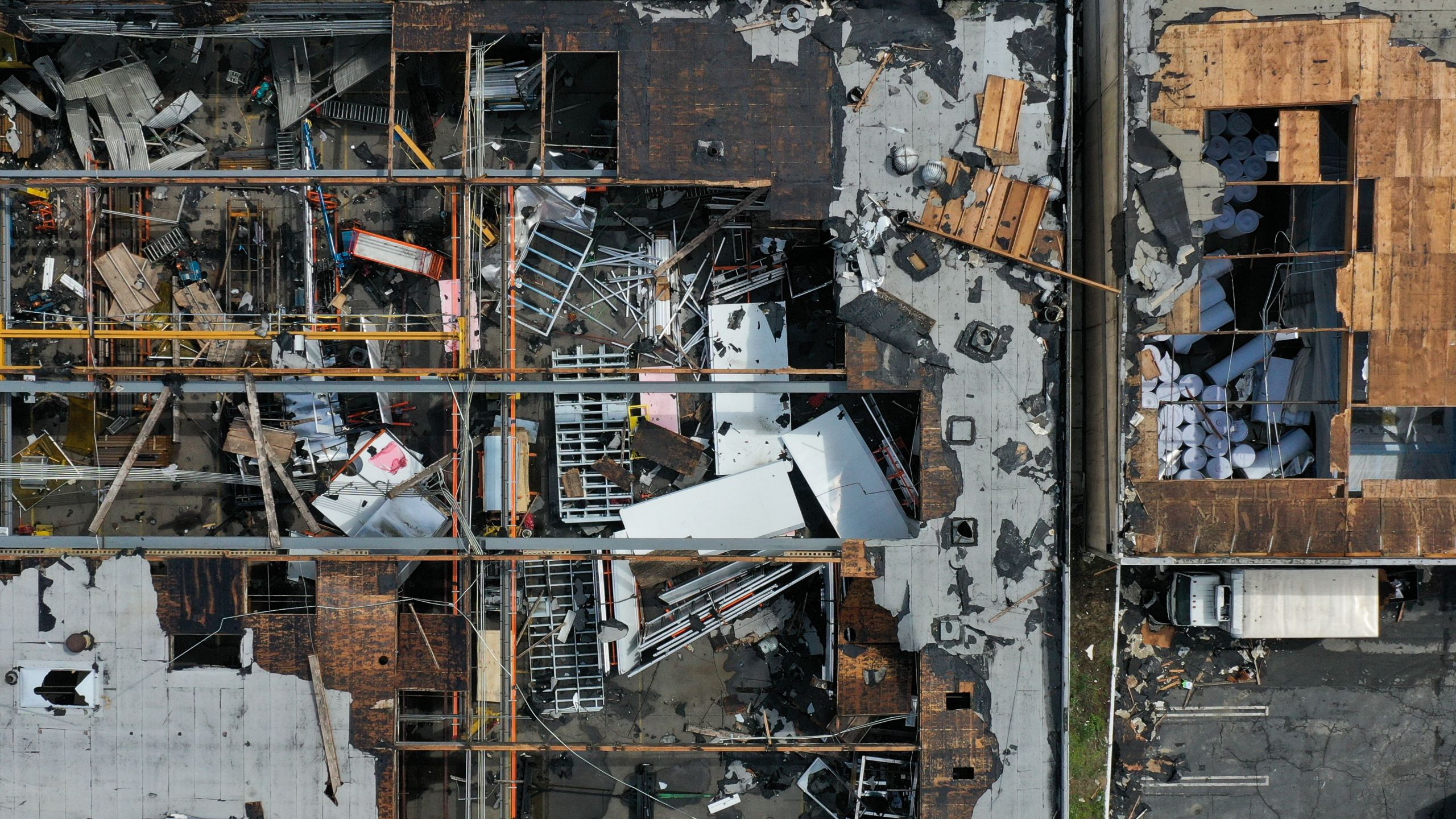 An aerial image shows damage to the roofs of industrial buildings from a tornado during a storm in Montebello on March 23, 2023. (Patrick T. Fallon / AFP via Getty Images)