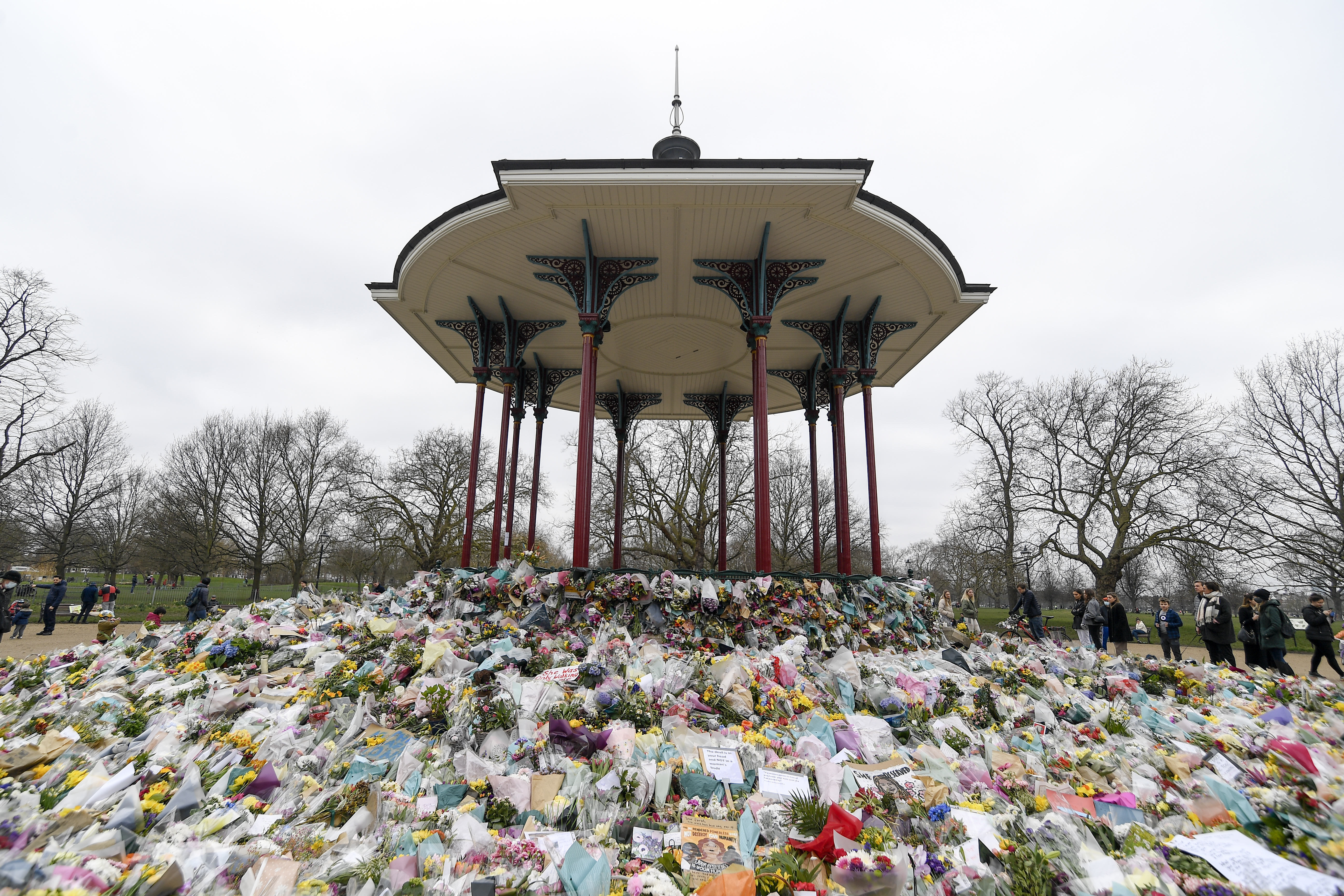 Floral tributes and messages surround the bandstand on Clapham Common in London, March 20, 2021, after the nearby disappearance of Sarah Everard. An independent review says London police have lost the confidence of the public because of deep-seated racism, misogyny and homophobia. The review released Tuesday March 21, 2023, was commissioned after Sarah Everard was raped and killed by a serving officer. (AP Photo/Alberto Pezzali)