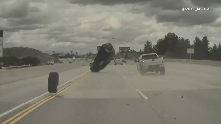 Dash-cam footage from a Tesla captured the moment a vehicle on the 118 Freeway in Chatsworth ran over a tire that had just come off a nearby pickup truck, launching the car into a midair spin on Mar. 23, 2023. (Anoop Khatra)