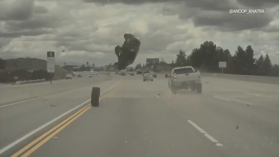 Dash-cam footage from a Tesla captured the moment a vehicle on the 118 Freeway in Chatsworth ran over a tire that had just come off a nearby pickup truck, launching the car into a midair spin on Mar. 23, 2023. (Anoop Khatra)  