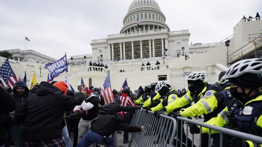 Violent insurrectionists loyal to President Donald Trump try to break through a police barrier on Jan. 6, 2021, at the Capitol in Washington. (AP Photo/Julio Cortez, File)