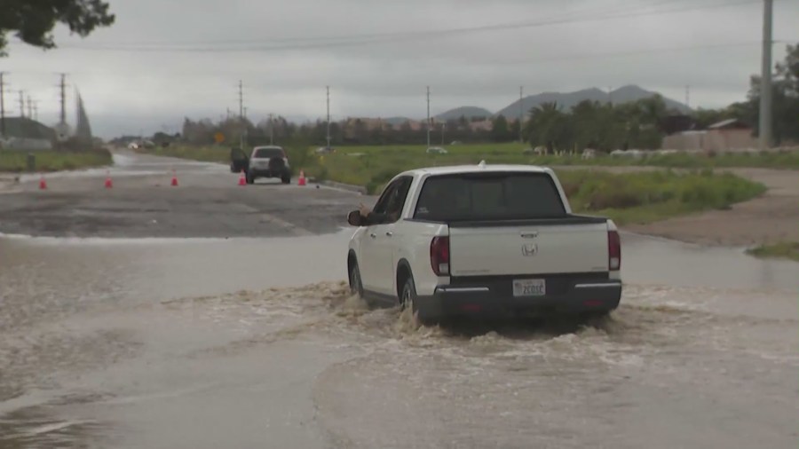 Driver traveling through completely flooded road in the Inland Empire. (KTLA)