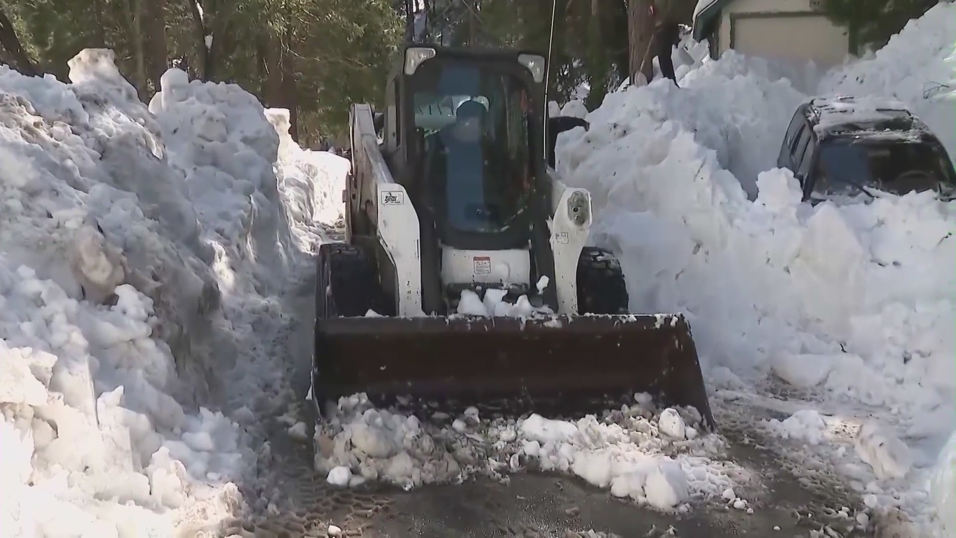 Locals and emergency crews dig out homes and roads after a historic winter snowstorm in San Bernardino County mountain communities. (KTLA)