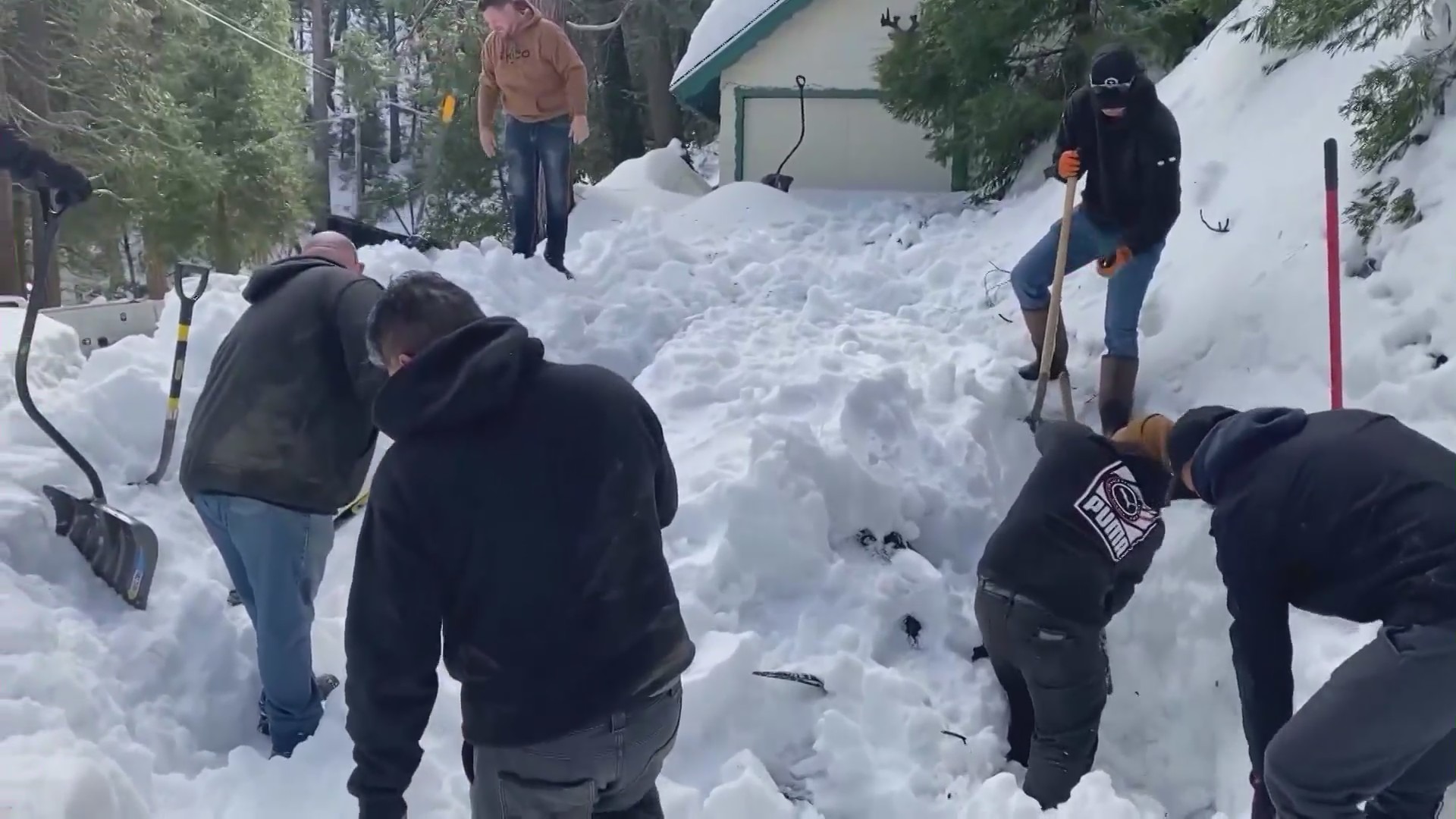 Mountain community residents digging out homes and roads after a historic winter snowstorm in San Bernardino County. (KTLA)