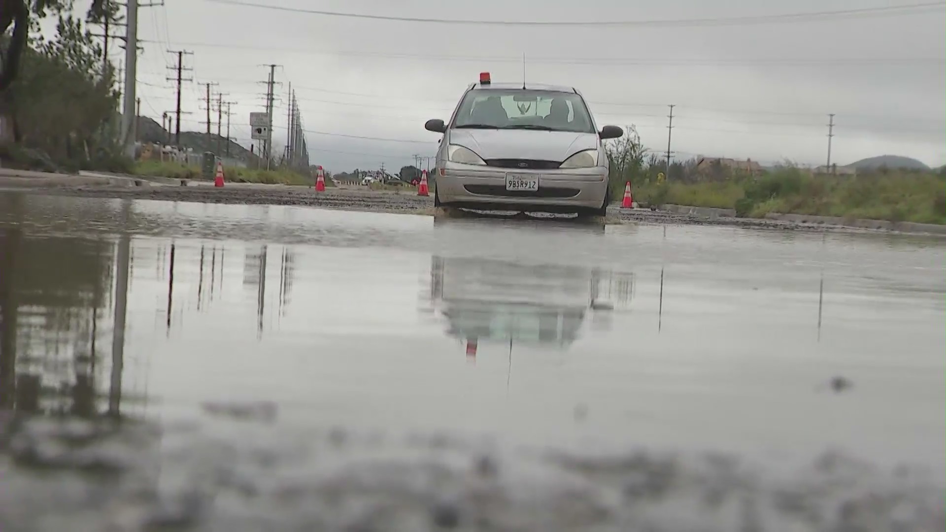 Driver traveling through completely flooded road in the Menifee. (KTLA)