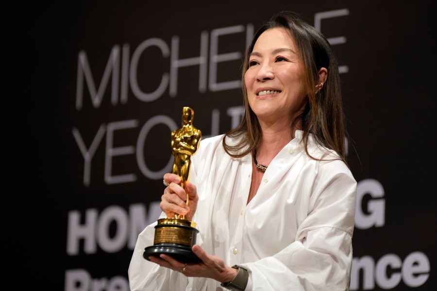 Malaysian actress Michelle Yeoh holds up the Oscar statuette during a press conference in Kuala Lumpur, Malaysia, Tuesday, April 18, 2023. Yeoh won the award for best performance by an actress in a leading role for "Everything Everywhere All at Once" at the Oscars on March 12. (AP Photo/Vincent Thian)