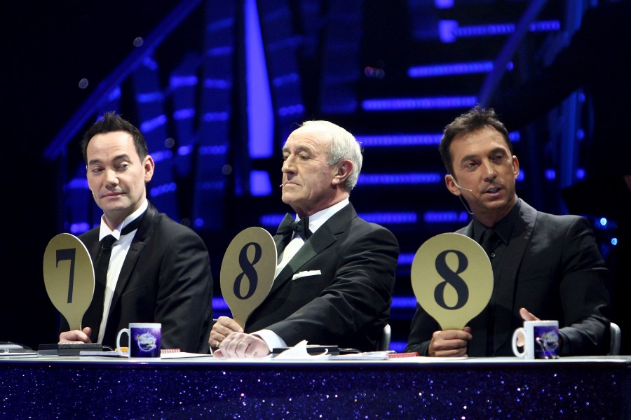 FILE - From left, judges Craig Revel Horwood, Len Goodman and Bruno Tonioli gesture, during the final dress rehearsal for the opening of the 'Strictly Come Dancing Live Tour' at the NIA, Birmingham, England, Jan. 20, 2012. Len Goodman, an urbane long-serving judge on “Dancing with the Stars” and “Strictly Come Dancing,” has died, his agent said Monday, April 24, 2023. He was 78. A former dancer, Goodman was a judge on “Strictly Come Dancing” for 12 years from its launch on the BBC in 2004. (David Jones/PA via AP, File)