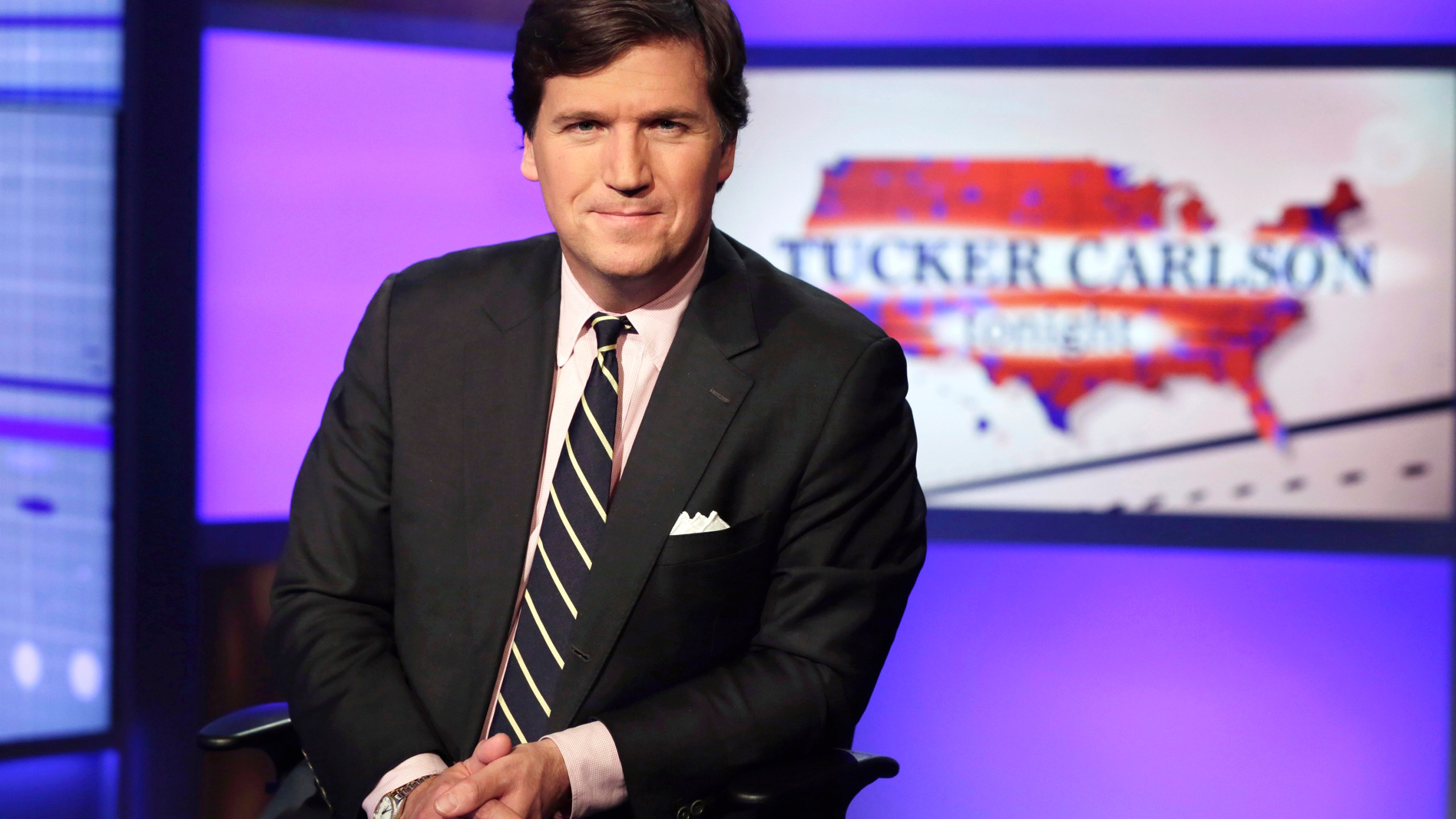 Tucker Carlson, host of "Tucker Carlson Tonight," poses for photos in a Fox News Channel studio on March 2, 2017, in New York. (AP Photo/Richard Drew, File)