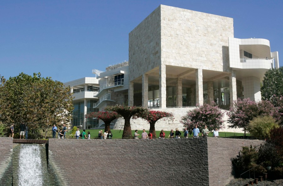 In this Oct. 9, 2005, file photo, visitors walk in the gardens at the J. Paul Getty Museum in Los Angeles. One of the earliest portraits of a person of color by a British artist will remain on public display after London’s National Portrait Gallery and the J. Paul Getty Museum in Los Angeles struck a 50 million-pound ($62 million) deal to buy it. The two institutions announced Wednesday, April 26, 2023, they had each pitched in 25 million pounds to acquire Joshua Reynolds’ depiction of an 18th-century Polynesian man, “Portrait of Mai.” The seven-foot high (2.1-meter) painting is considered a masterpiece by the renowned portrait artist and is the first known grand depiction of a nonwhite subject in British art. (AP Photo/Ric Francis, File)