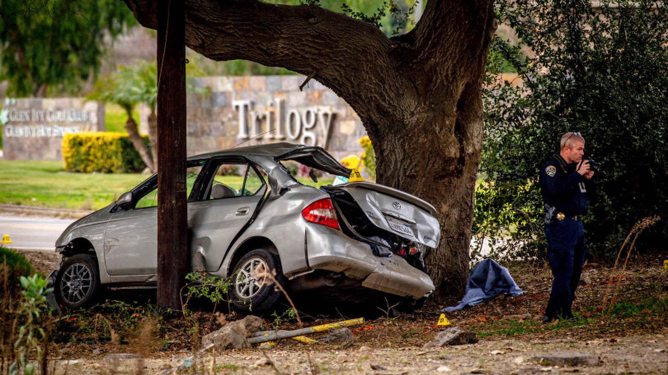 FILE - An officer with the California Highway Patrol's (CHP) Multidisciplinary Accident Investigation Team (MAIT) investigates the scene of a deadly crash in the Temescal Valley, south of Corona, Calif., Monday, Jan. 20, 2020. A jury found a Southern California man guilty Friday, April 28, 2023, in the killings of three teenage boys after they played a doorbell-ringing prank on him in 2020. (Watchara Phomicinda/The Orange County Register via AP, File)