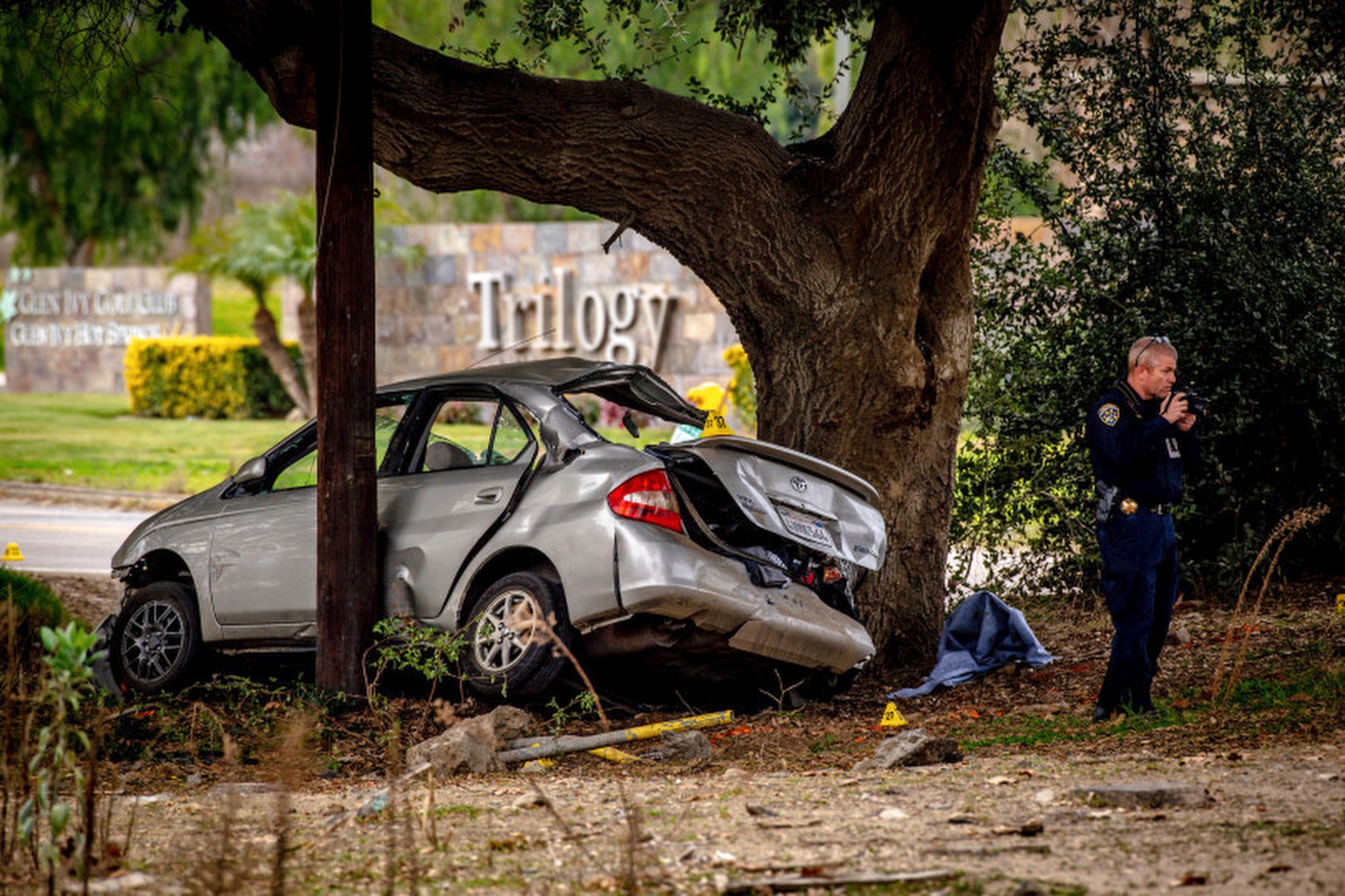 FILE - An officer with the California Highway Patrol's (CHP) Multidisciplinary Accident Investigation Team (MAIT) investigates the scene of a deadly crash in the Temescal Valley, south of Corona, Calif., Monday, Jan. 20, 2020. A jury found a Southern California man guilty Friday, April 28, 2023, in the killings of three teenage boys after they played a doorbell-ringing prank on him in 2020. (Watchara Phomicinda/The Orange County Register via AP, File)