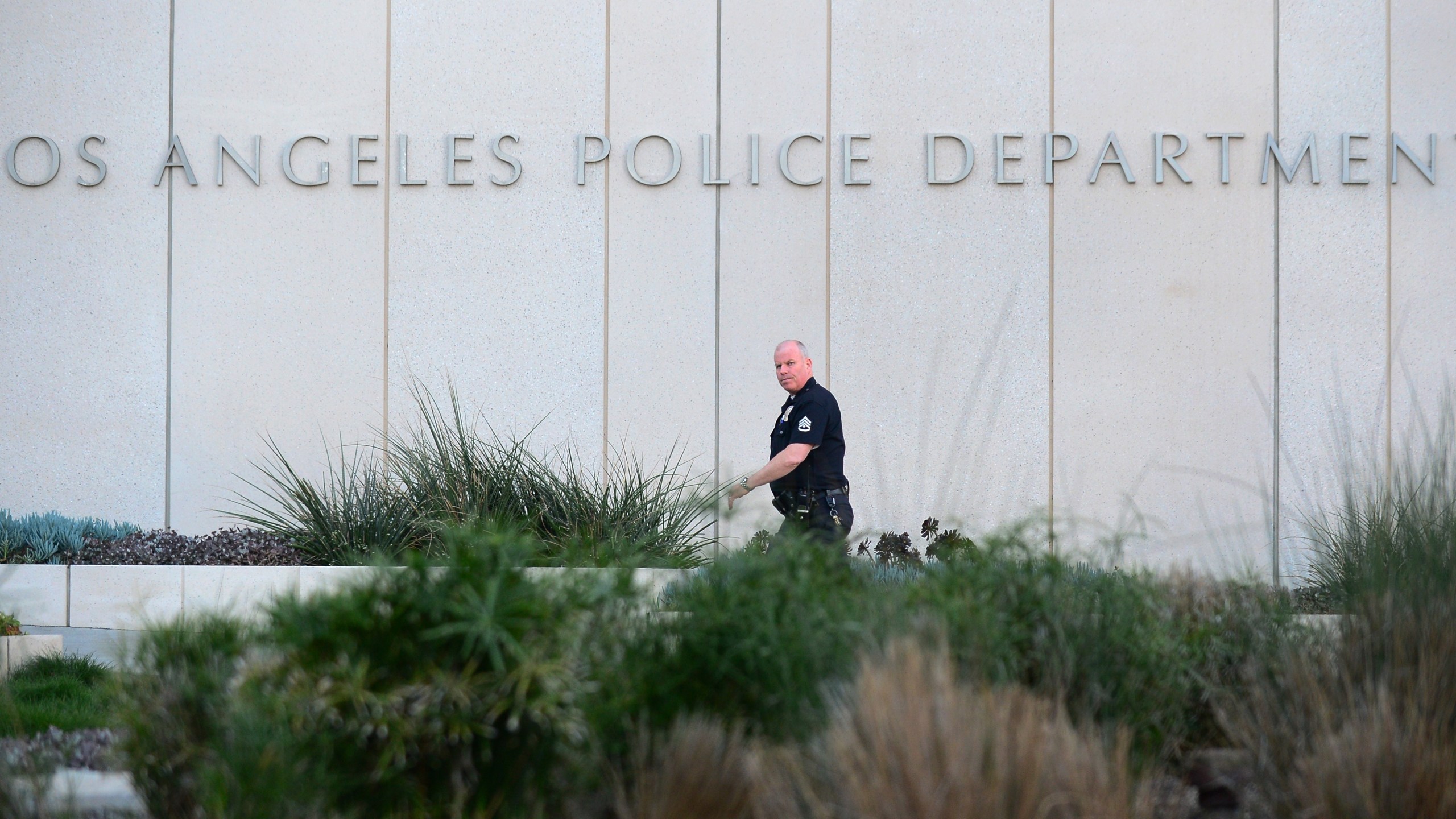 A Los Angeles Police Department officer walks to police headquarters in downtown Los Angeles on Feb. 12, 2013, (Frederic J. Brown/ AFP via Getty Images)