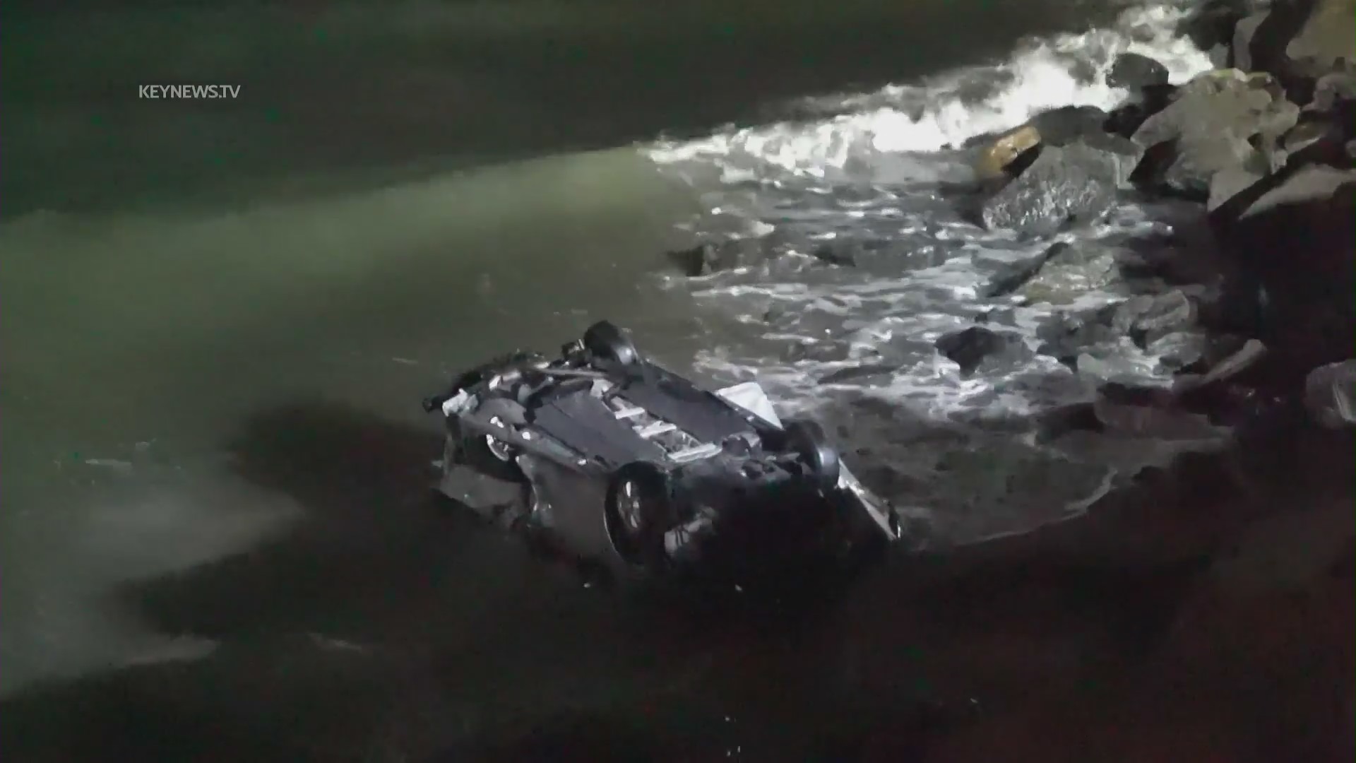 A driver allegedly under the influence smashed into parked cars along PCH on April 8, 2023, sending them careening toward pedestrians on the oceanside rocks below. (KeyNews.TV)