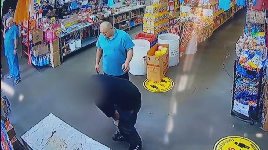 Security video shows a victim entering a nearby shop for help after he was shot in a Northridge strip mall on April 15, 2023. (Northridge Ice Cream)