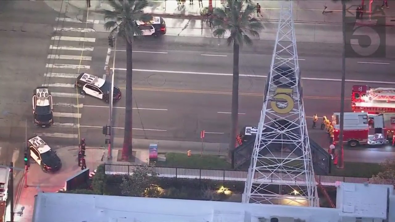 A man was seen climbing the KTLA 5 radio tower in Hollywood while holding a sign that read, “Free Billie Eilish” as authorities worked to remove him on April 25, 2023. (KTLA)