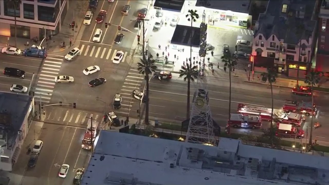 A man was seen climbing the KTLA 5 radio tower in Hollywood while holding a sign that read, “Free Billie Eilish” as authorities worked to remove him on April 25, 2023. (KTLA)