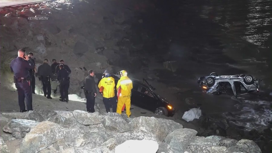 A driver allegedly under the influence smashed into parked cars along PCH on April 8, 2023, sending them careening toward pedestrians on the oceanside rocks below. (KeyNews.TV)