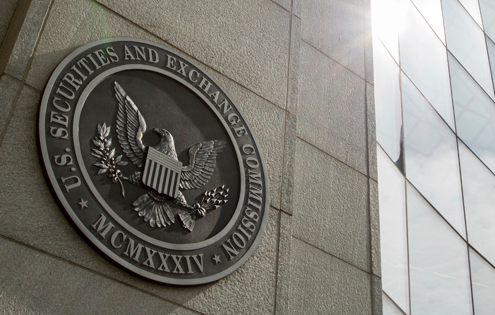 FILE - The seal of the U.S. Securities and Exchange Commission at SEC headquarters in Washington is seen, June 19, 2015. A bipartisan group of more than a two dozen lawmakers are asking the SEC to put the brakes on an initial public offering by Chinese fast fashion retailer Shein until it verifies it does not use forced labor from the country’s predominantly Muslim Uyghur population. (AP Photo/Andrew Harnik, File)