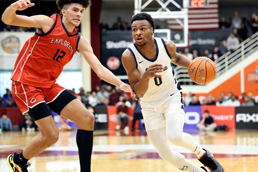 FILE -Sierra Canyon's Bronny James (0) drives against Christopher Columbus during a high school basketball game at the Hoophall Classic, Monday, Jan. 16, 2023, in Springfield, Mass. LeBron James' oldest son, Bronny, says he will play basketball at the University of Southern California in the fall. Bronny James abruptly announced his much-anticipated decision on social media Saturday, May 6, 2023. (AP Photo/Gregory Payan, File)