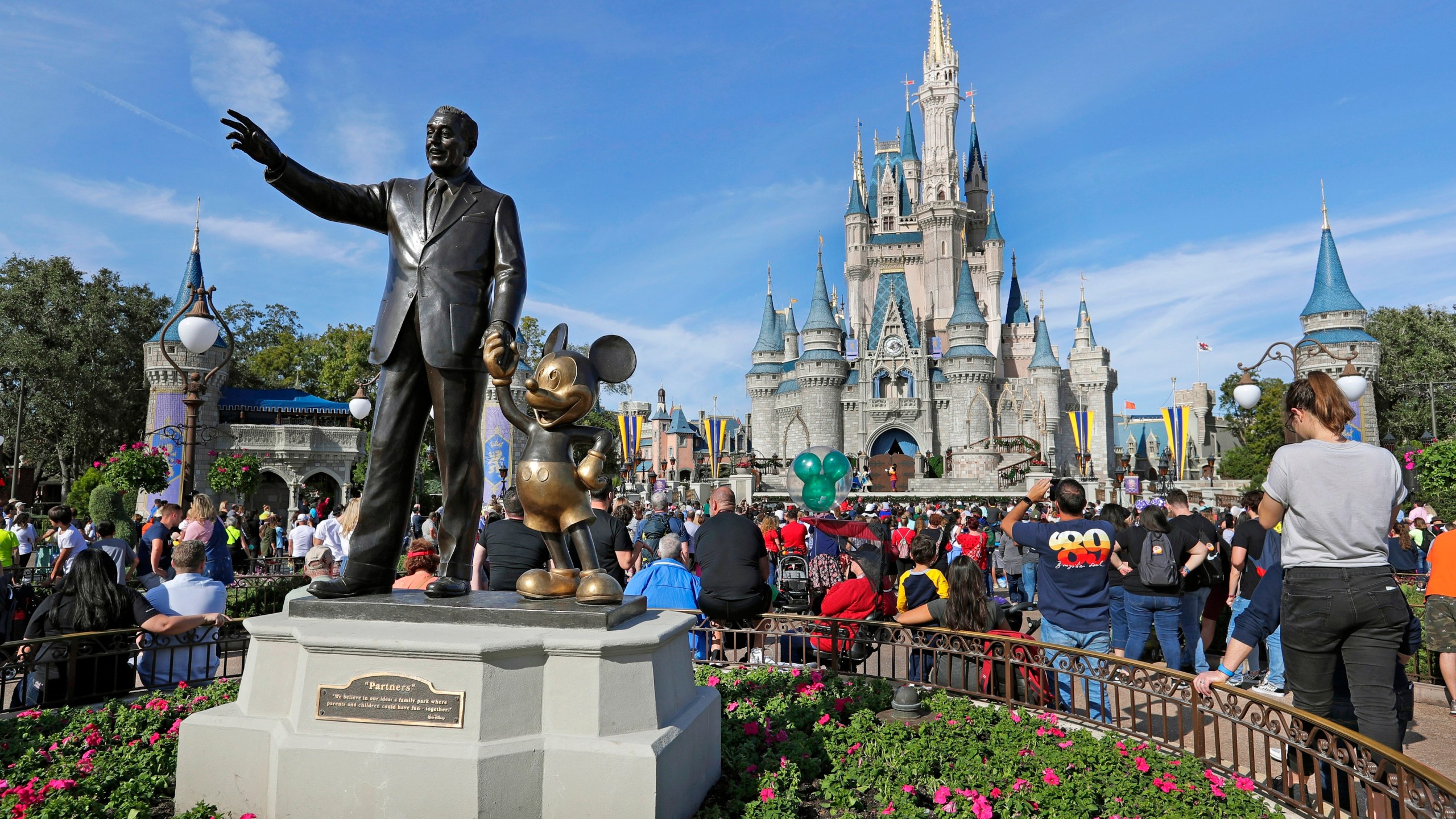 FILE - A statue of Walt Disney and Micky Mouse stands in front of the Cinderella Castle at the Magic Kingdom at Walt Disney World in Lake Buena Vista, Fla., Jan. 9, 2019. It’s going on six months since Bob Iger returned to The Walt Disney Co., and while there’s been plenty of issues to keep him busy, one has definitely been top of mind: reconnecting with the Disney theme park die-hards and restoring their faith in the brand. (AP Photo/John Raoux, File)