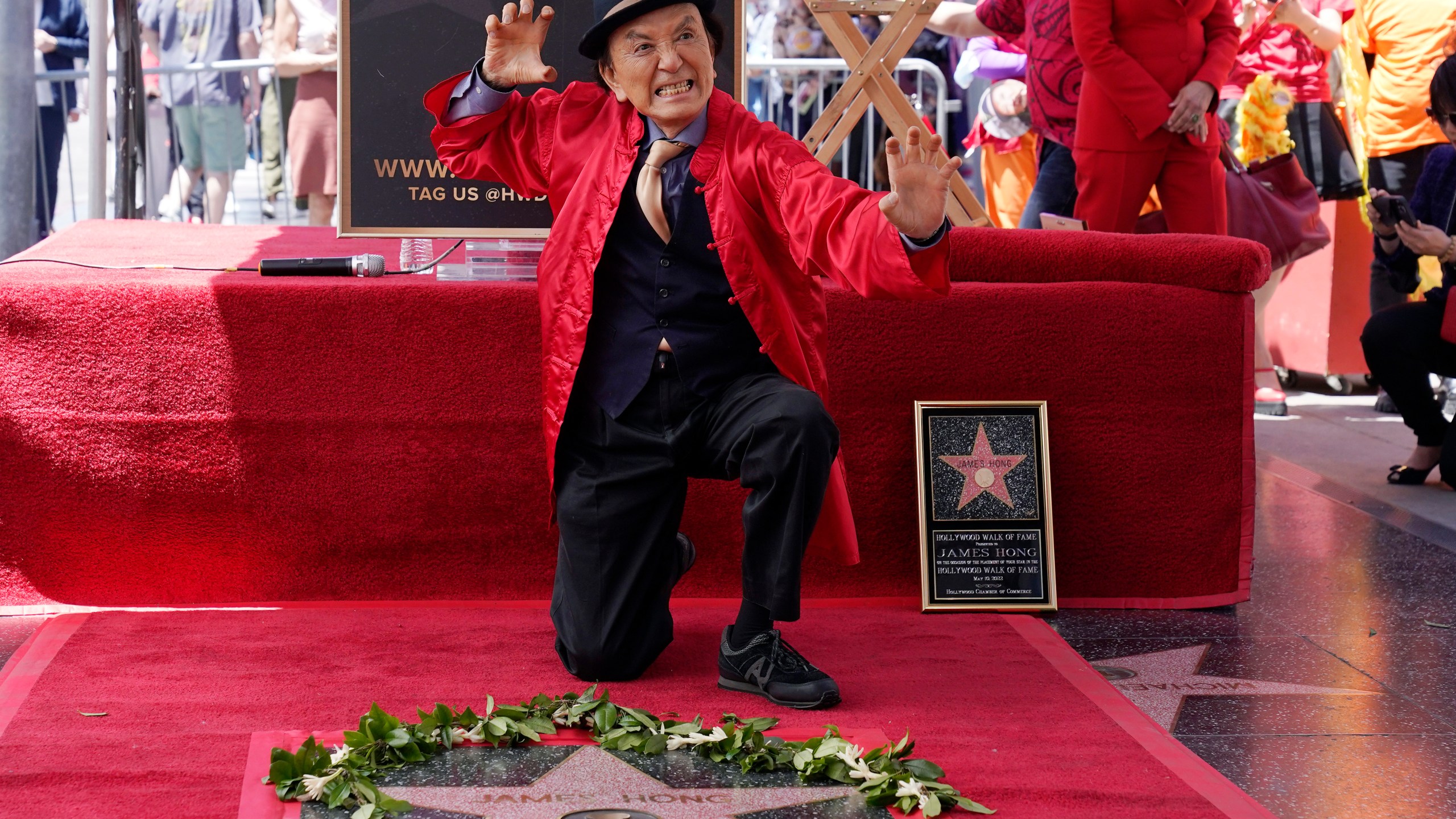 FILE - Actor James Hong poses after being honored with a star on the Hollywood Walk of Fame on May 10, 2022, in the Hollywood section of Los Angeles. has a starring role in the new “Gremlins” animated prequel, “Secrets of the Mogwai,” and pops up in “American Born Chinese” on Disney+. (AP Photo/Mark J. Terrill, File)