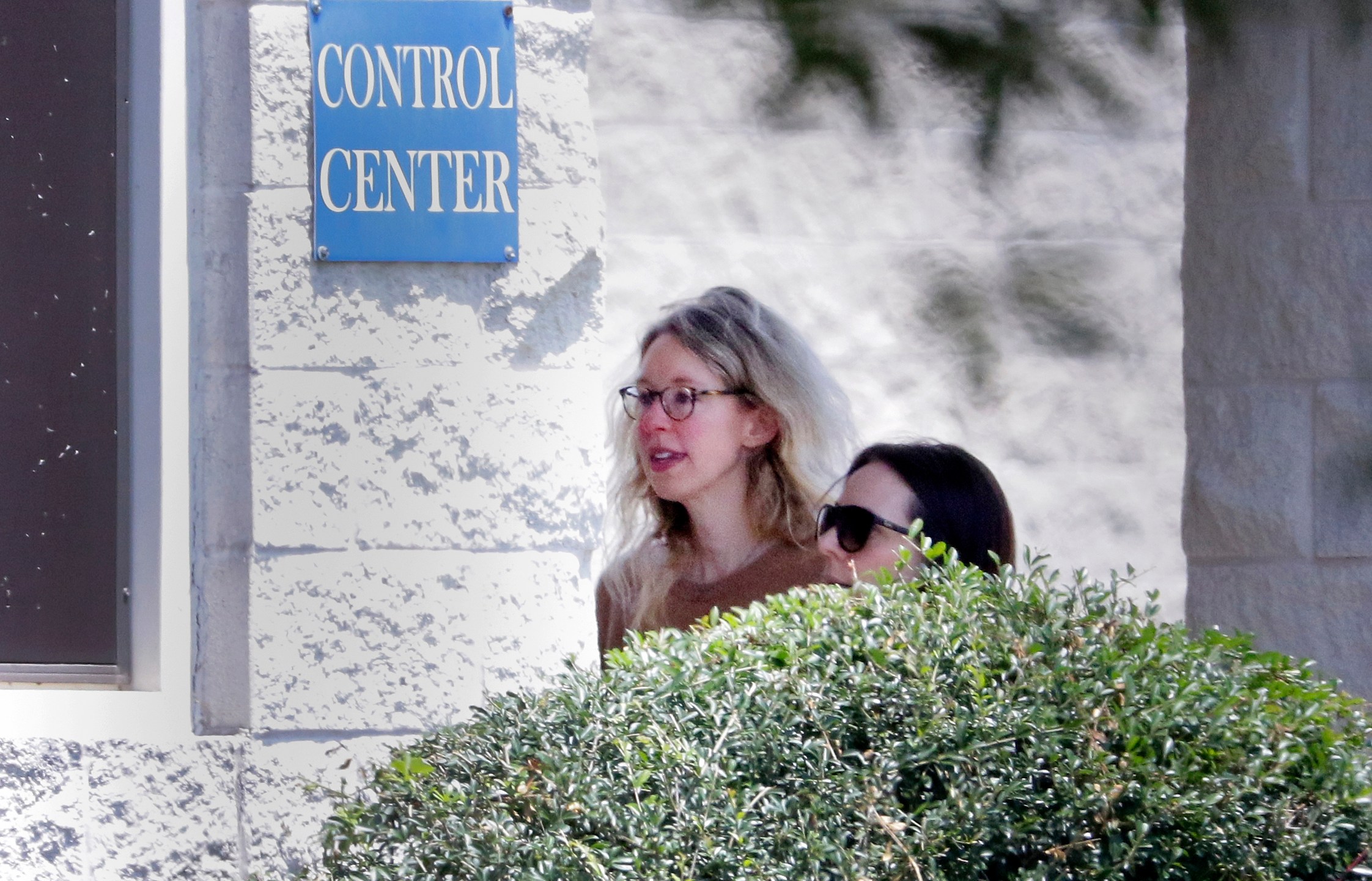 Disgraced Theranos CEO Elizabeth Holmes, left, is escorted by prison officials into a federal women’s prison camp on May 30, 2023, in Bryan, Texas. (Michael Wyke/Associated Press)