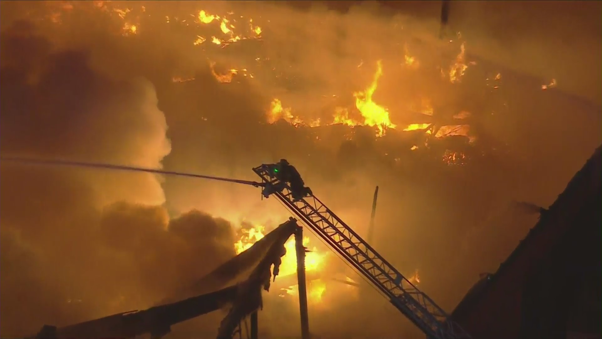 A firefighter battles a third-alarm blaze in Commerce on May 5, 2023. (KTLA)