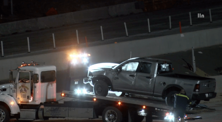 A truck with major damage is towed from the scene of a road-rage shooting and crash in Corona on April 30, 2023. (LOUDLABS)