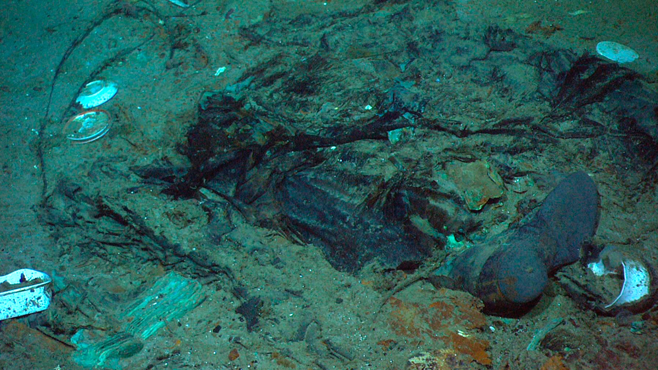 FILE - This 2004 photo provided by the Institute for Exploration, Center for Archaeological Oceanography/University of Rhode Island/NOAA Office of Ocean Exploration, shows the remains of a coat and boots in the mud on the sea bed near the Titanic's stern. Rescuers are racing against time to find the missing submersible carrying five people, who were reported overdue Sunday night, June 18, 2023. (Institute for Exploration, Center for Archaeological Oceanography/University of Rhode Island/NOAA Office of Ocean Exploration, File)