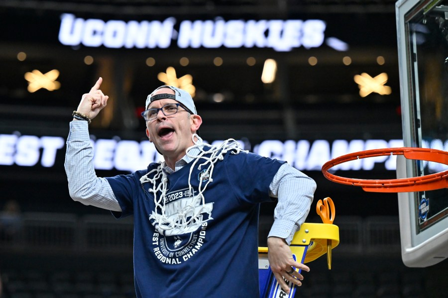 FILE - UConn head coach Dan Hurley celebrates after cutting down the netting from the 82-54 win against Gonzaga of an Elite 8 college basketball game in the West Region final of the NCAA Tournament, Saturday, March 25, 2023, in Las Vegas. UConn men’s basketball coach Dan Hurley has cashed in on the Huskies national championship, agreeing to a new six-year, $31.5 million contract, the school announced Thursday, June 22, 2023. (AP Photo/David Becker, File)