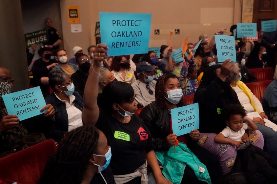 People supporting renters and a ramp down of the eviction moratorium hold up signs during a Oakland City Council special community and economic development committee at City Hall in Oakland, Calif., Tuesday, April 11, 2023. Eviction moratoriums were set in place across the U.S. at the start of the pandemic and most have expired, but not in the Bay Area cities of Oakland, San Francisco and Berkeley, where housing and rates of homelessness are both high. Housing advocates say low-income tenants still need protections. Oakland's eviction ban lifts July 15. (AP Photo/Jeff Chiu)