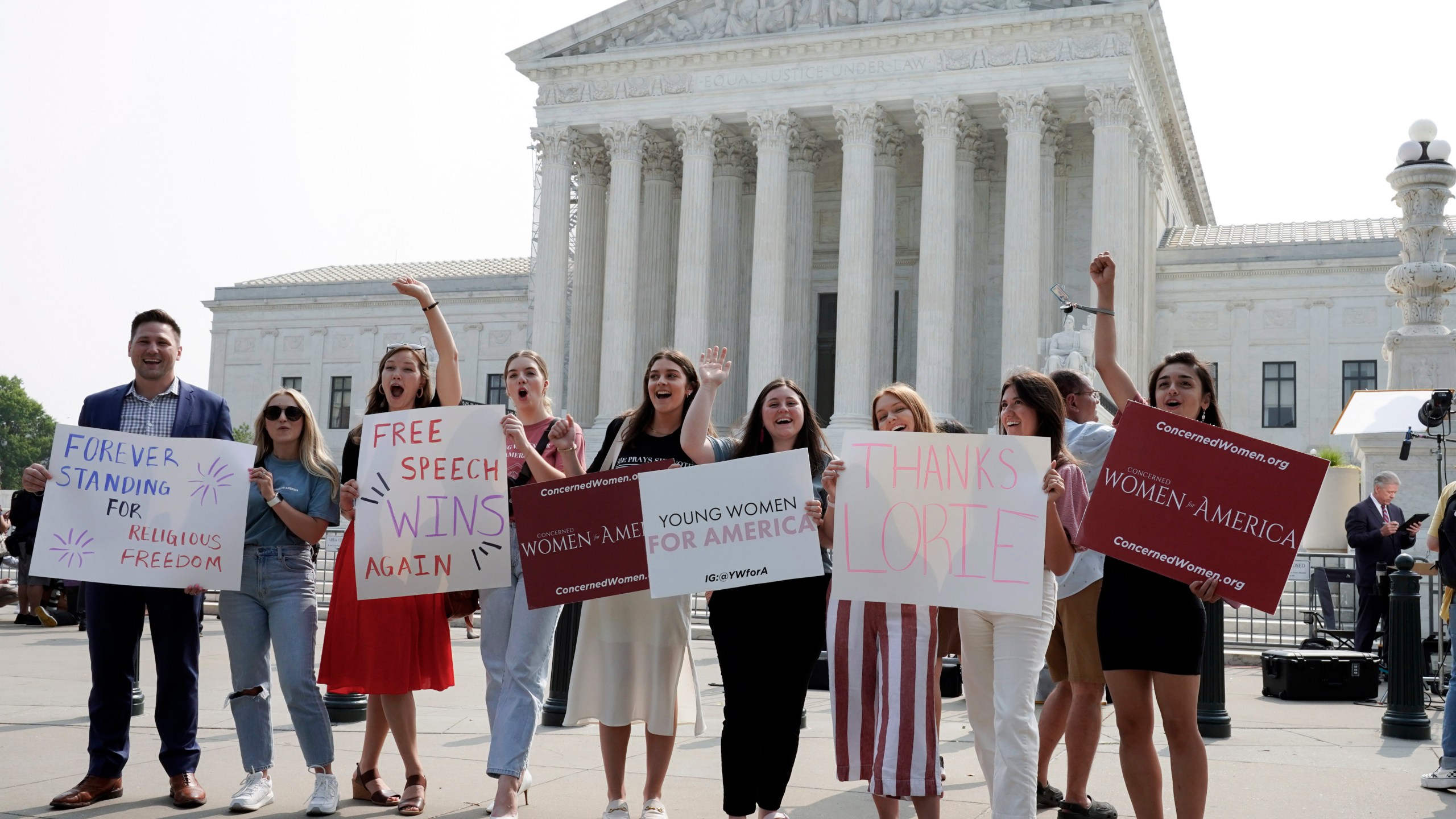 People react outside of the Supreme Court Friday, June 30, 2023, in Washington, after the Supreme Court's conservative majority ruled that a Christian graphic artist who wants to design wedding websites can refuse to work with same-sex couples. The court ruled 6-3 for designer Lorie Smith despite a Colorado law that bars discrimination based on sexual orientation, race, gender and other characteristics. Smith had argued that the law violates her free speech rights. (AP Photo/Mariam Zuhaib)