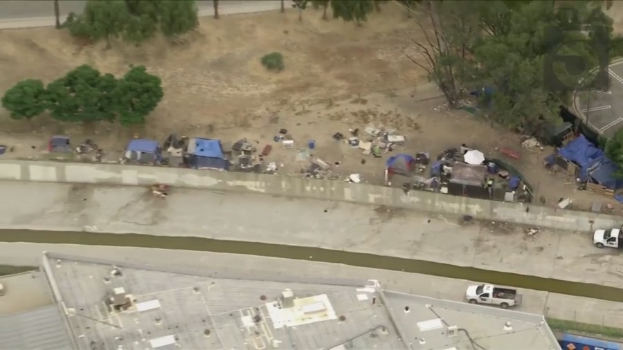 A homeless encampment near the Chatsworth Metrolink station, shown on June 1, 2023, has riled residents. (KTLA)