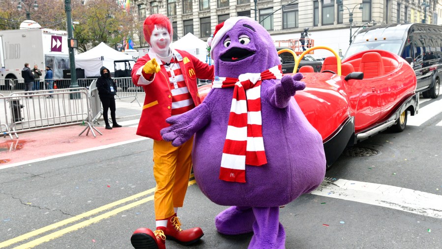 NEW YORK, NEW YORK - NOVEMBER 24: Ronald McDonald (wearing face shield) and Grimace appear in the 94th Annual Macy's Thanksgiving Day Parade¨ on November 24, 2020 in New York City. The World-Famous Macy's Thanksgiving Day Parade¨ kicks off the holiday season for millions of television viewers watching safely at home. (Photo by Eugene Gologursky/Getty Images for Macy's, Inc.)