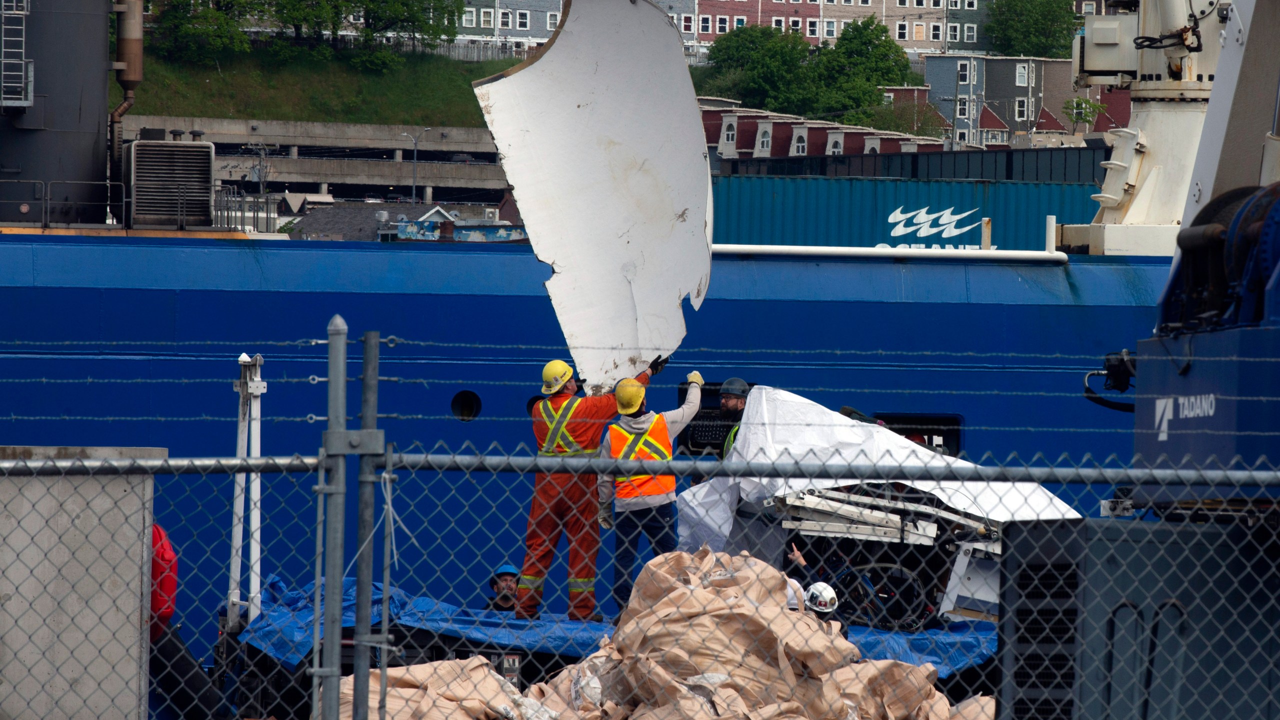 Debris from the Titan submersible, recovered from the ocean floor near the wreck of the Titanic, is unloaded from the ship Horizon Arctic at the Canadian Coast Guard pier in St. John's, Newfoundland, Wednesday, June 28, 2023. (Paul Daly/The Canadian Press via AP)