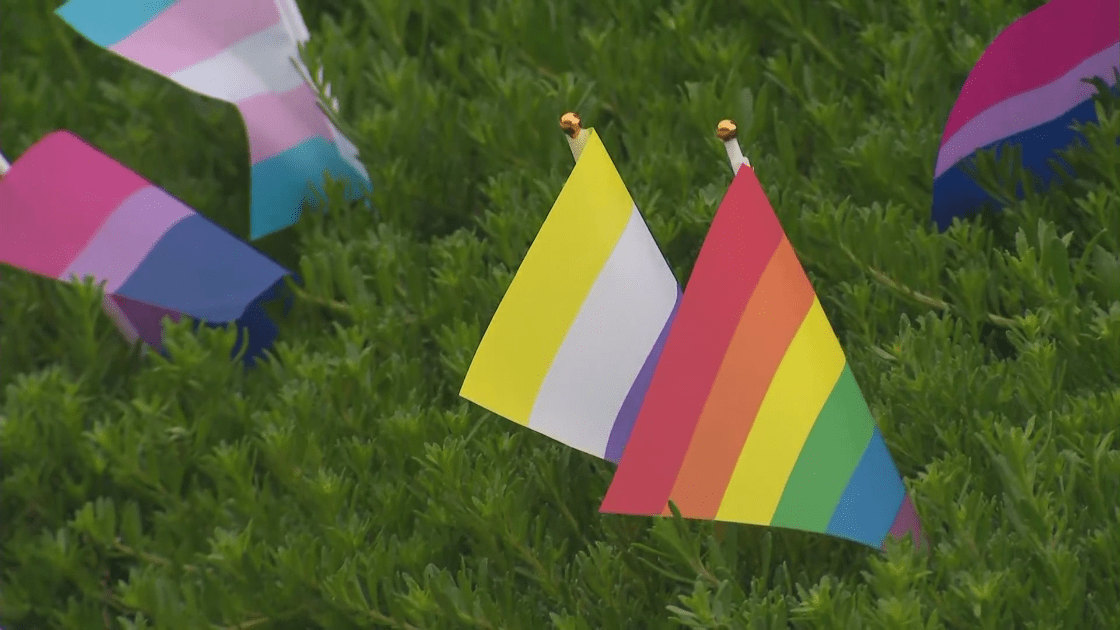 Demonstrators display Pride flags outside the Orange County administration building on June 6, 2023. (KTLA)