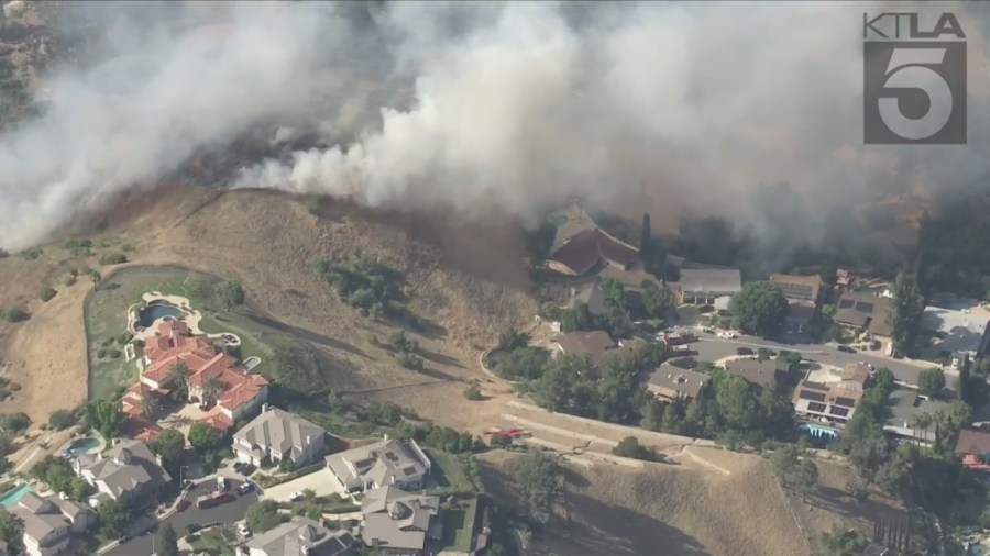 West Hills brush fire threatens a neighborhood